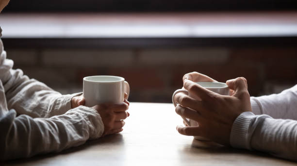 Couple talking over coffee.